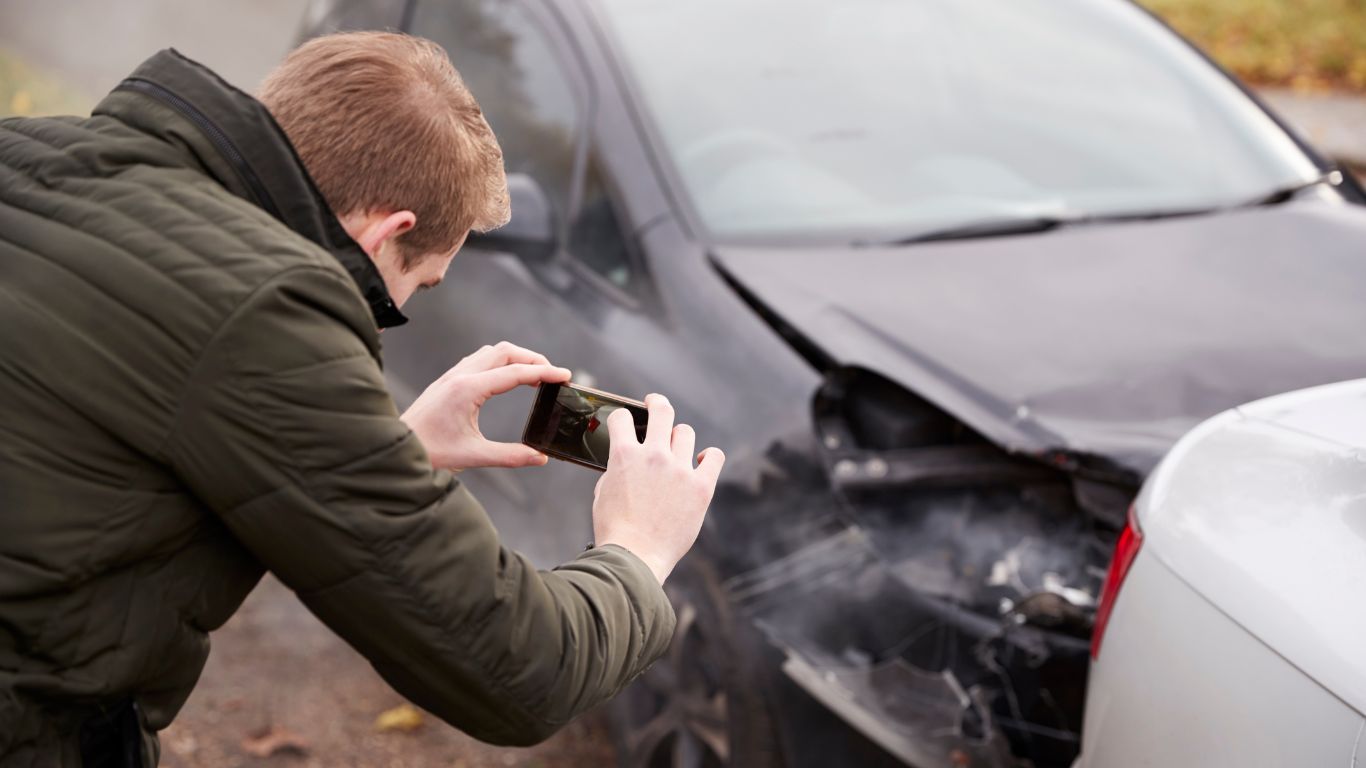 Man Taking Photo of Car Accident