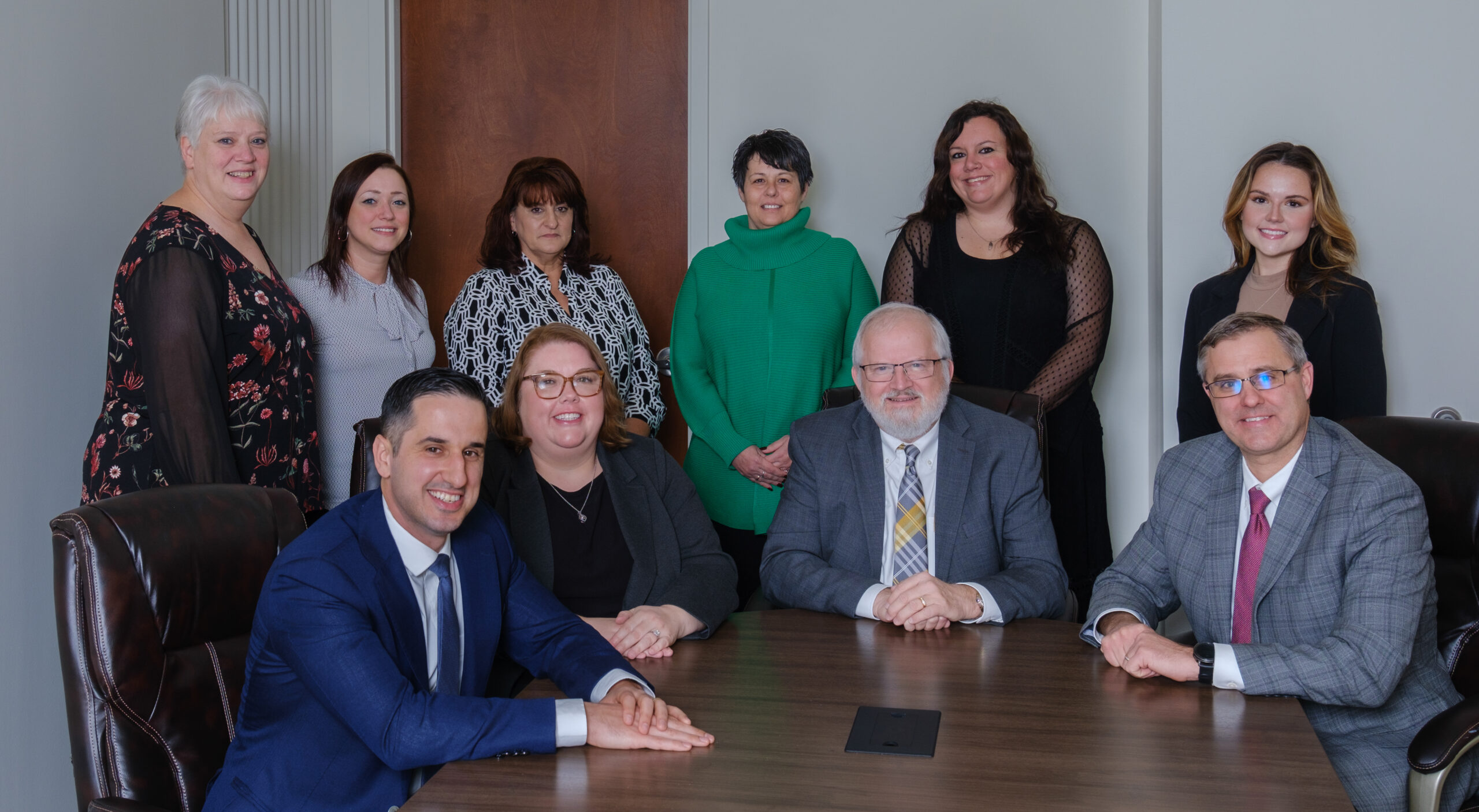 lawyers in suits posing at a round table